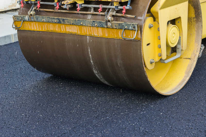 asphalt roller compacting new parking lot