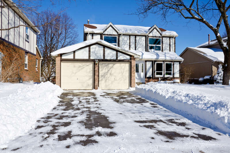 Asphalt driveway covered with snow in CO Springs